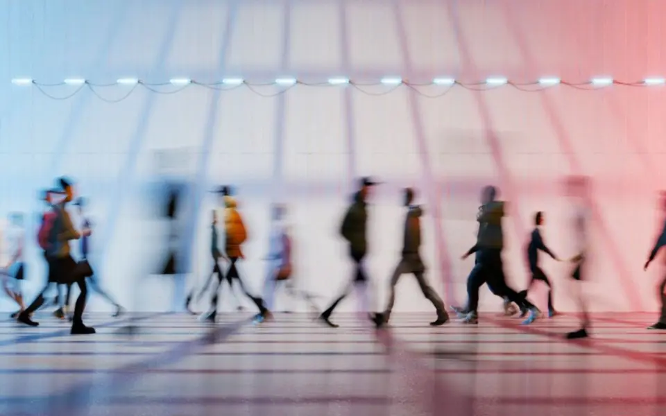 People moving through a blue and red urban interior